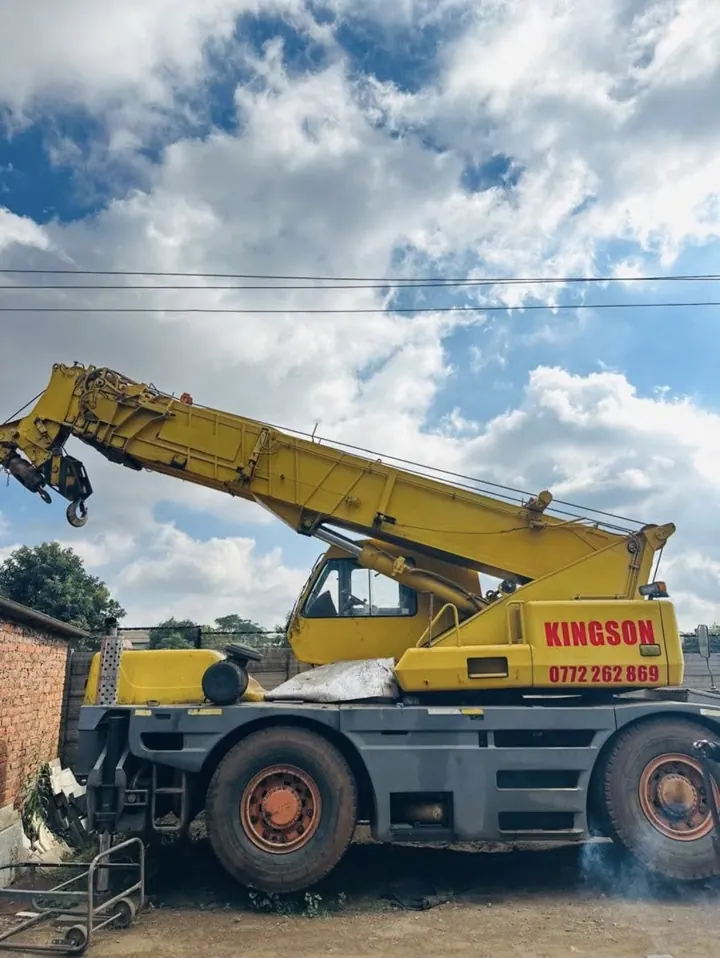 Kingson Engineering’s yellow telescopic mobile crane in a yard, with its boom raised and KINGSON lettering on the counterweight.
